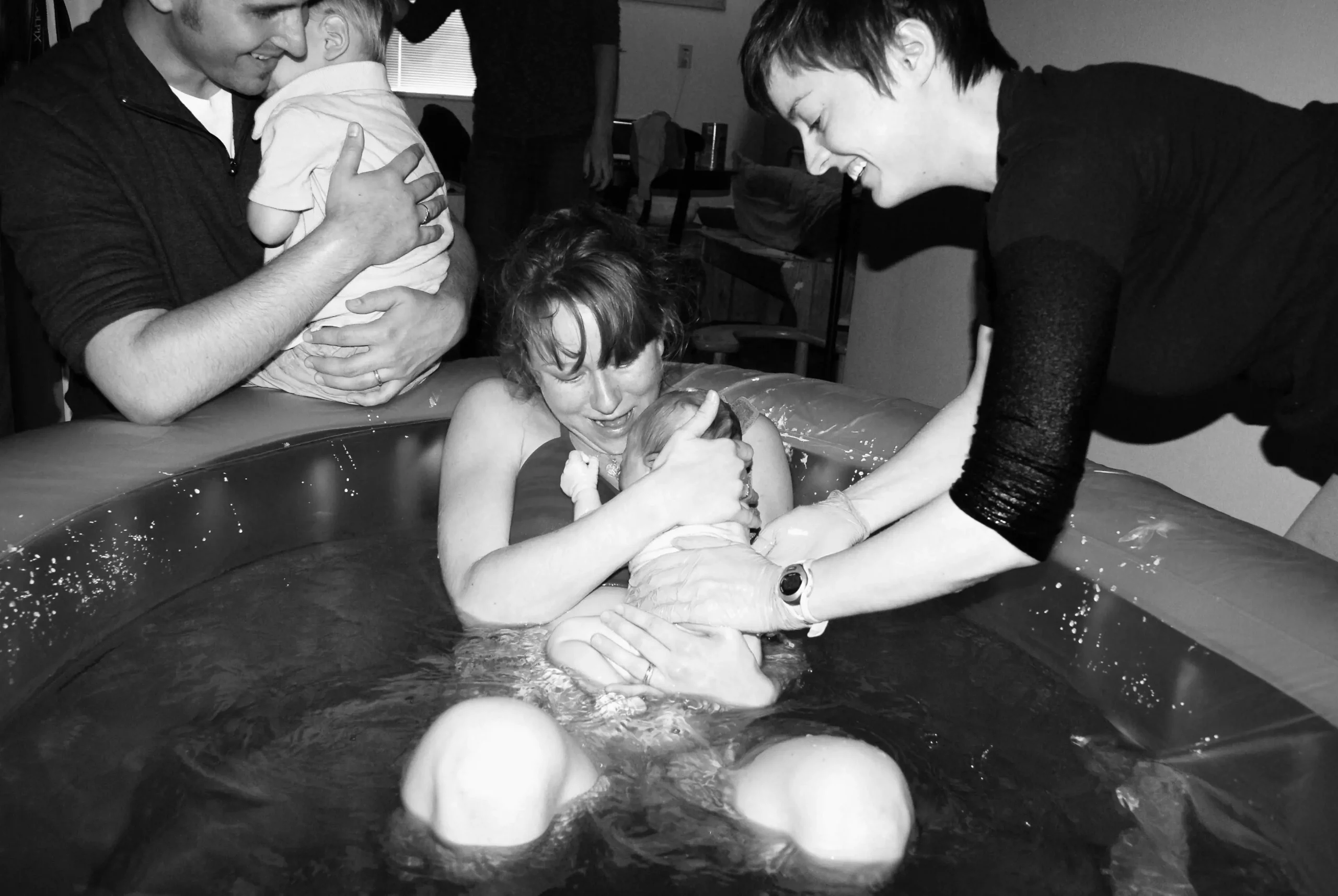 The Safety of Waterbirth A Twin Cities Midwifery mama receiving her baby in the water